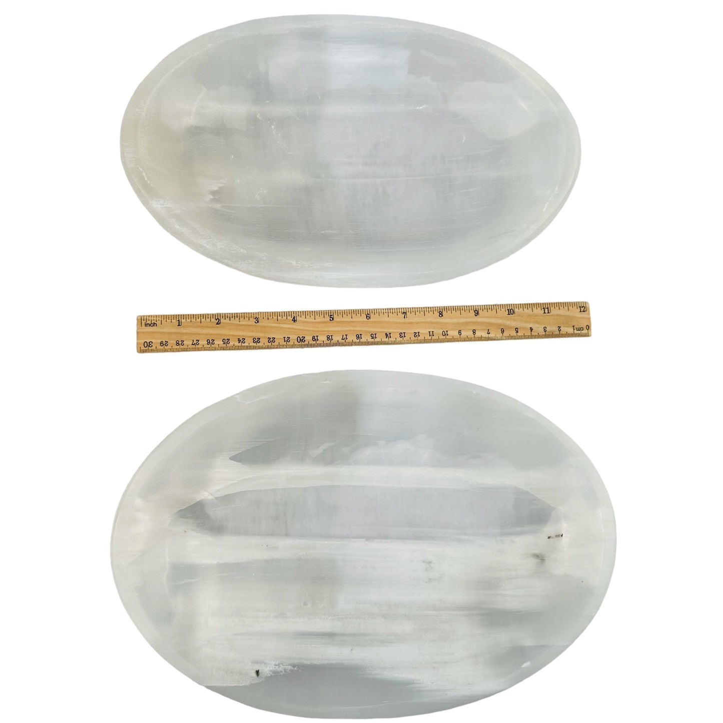 selenite bowls next to a ruler for size reference