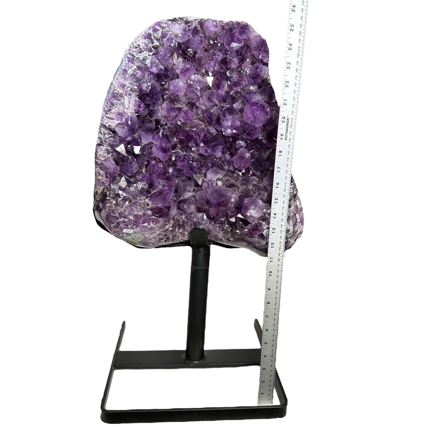 amethyst cluster next to a ruler for size reference