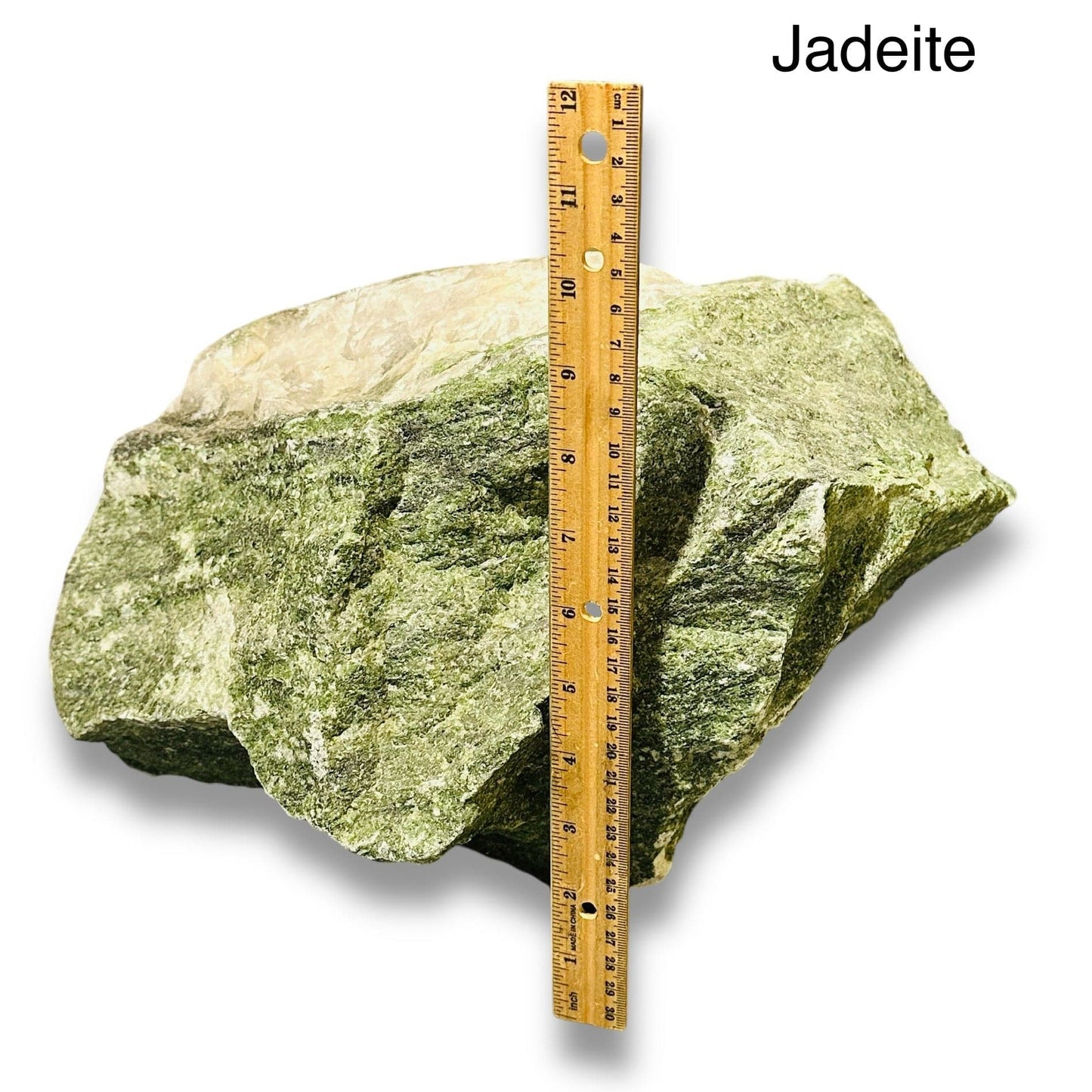 rough stone crystal next to a ruler for size reference