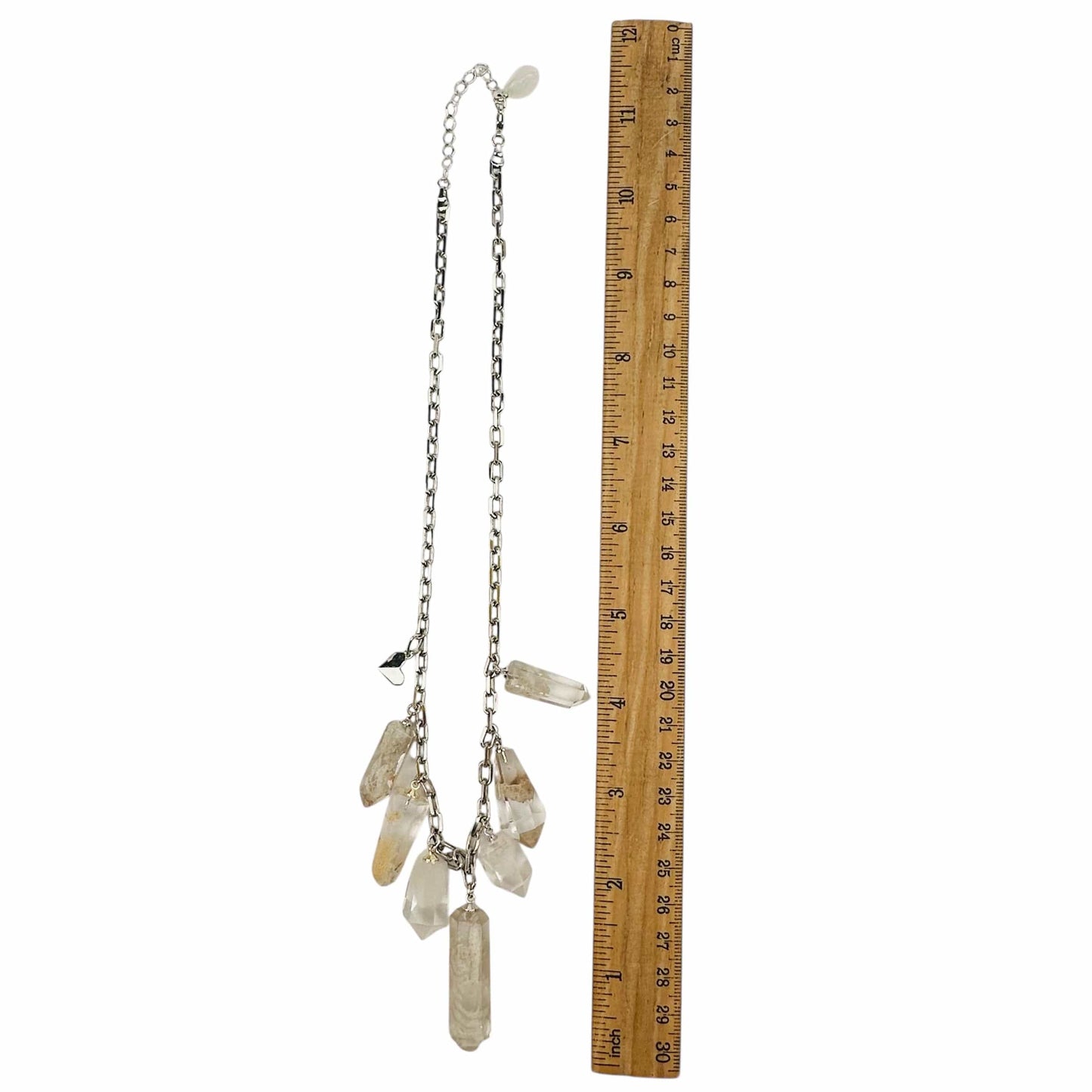 crystal charm necklace displayed next to a ruler for size reference