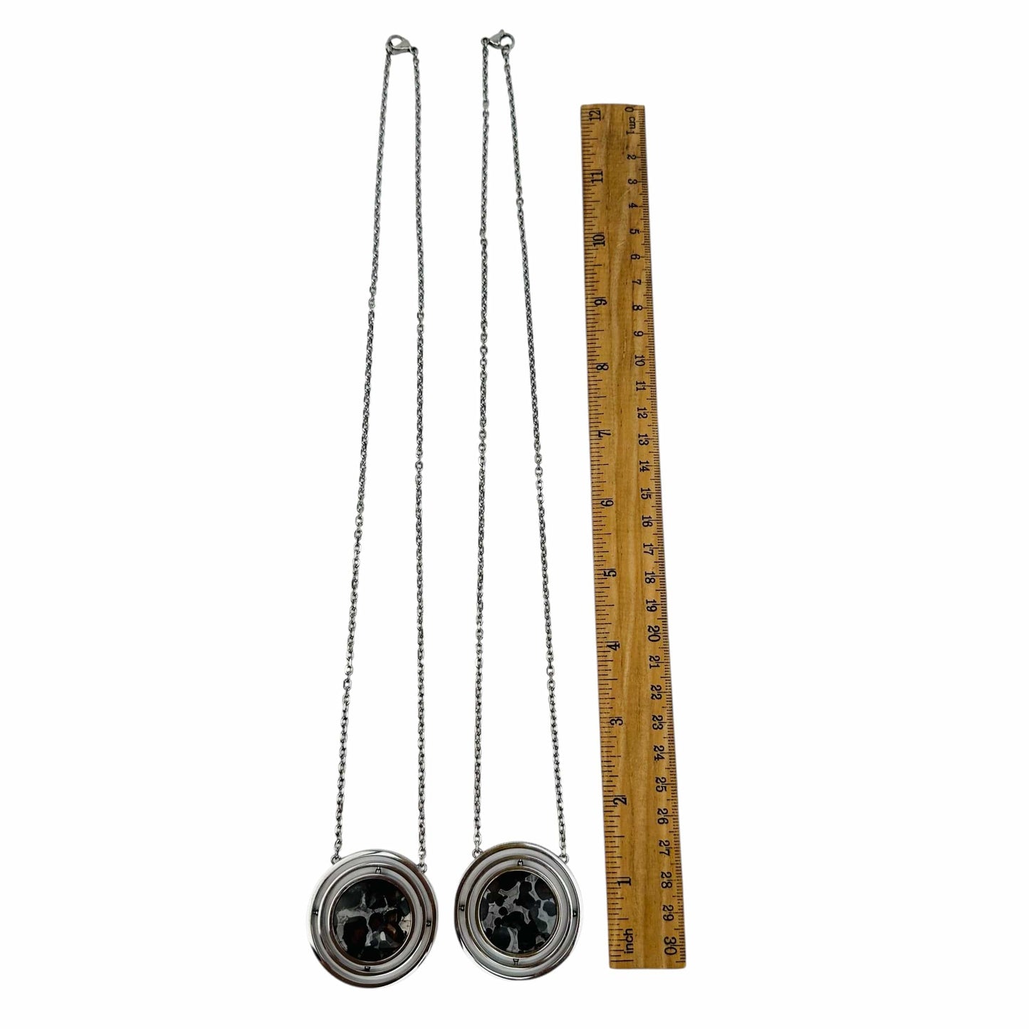 necklaces next to a ruler for size reference