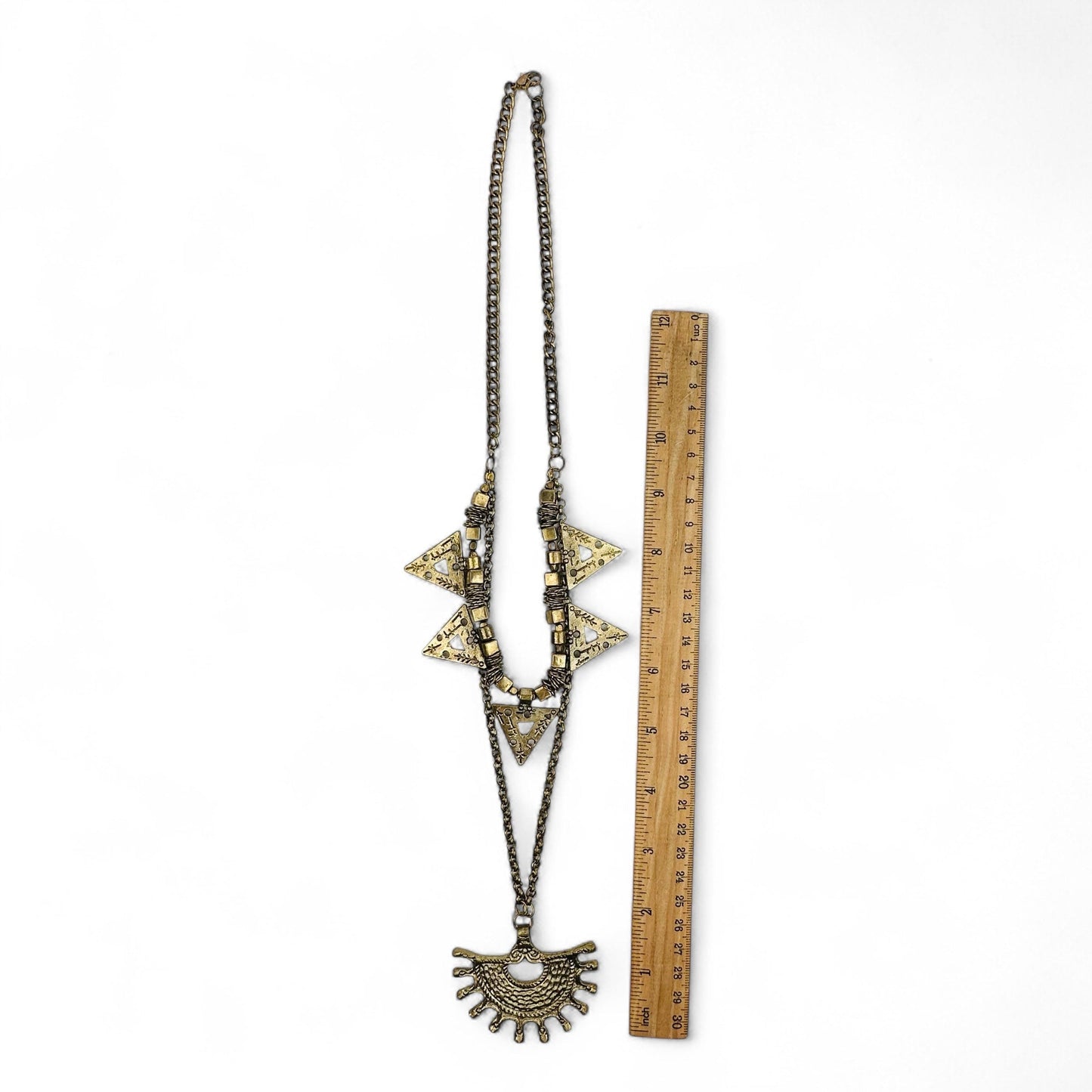 necklace next to a ruler for size reference