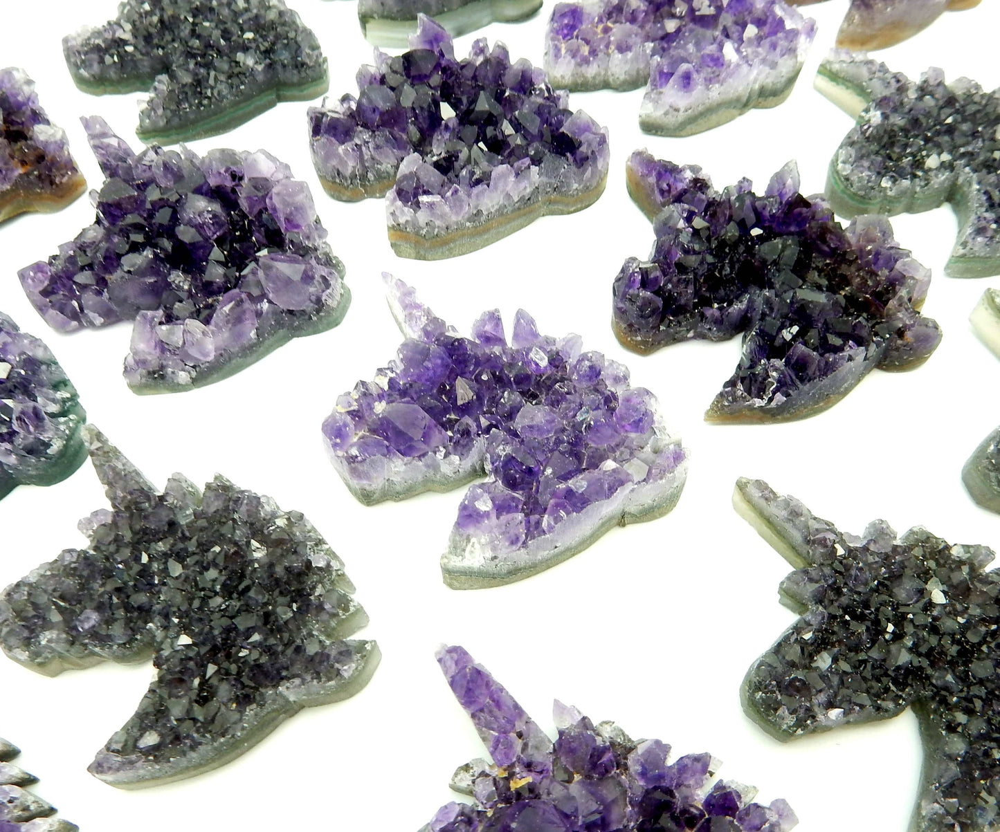 up close shot of amethyst unicorn cabochons on white background