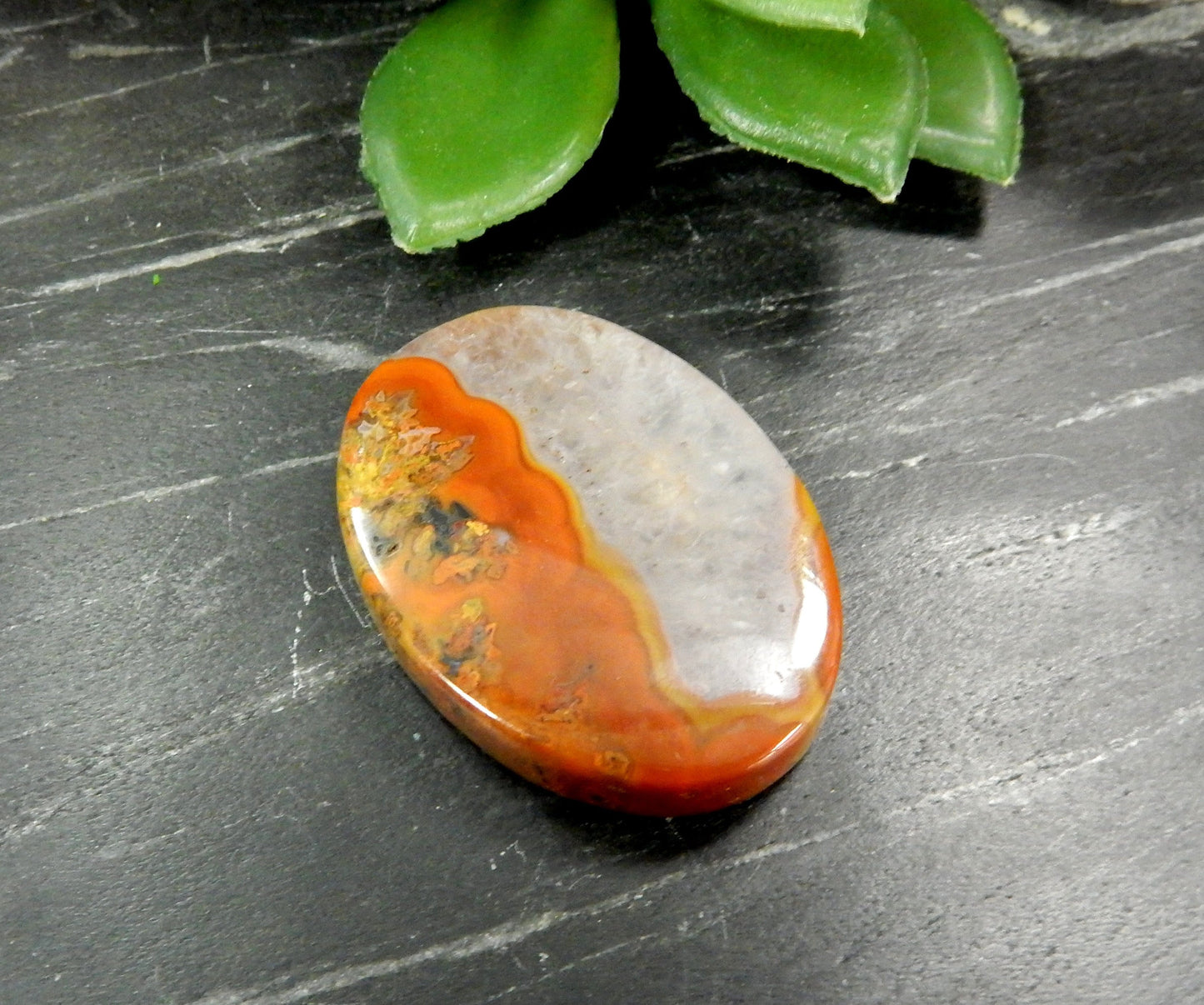 Up close shot of Red Chinese Agate Oval Shaped Bead on black background