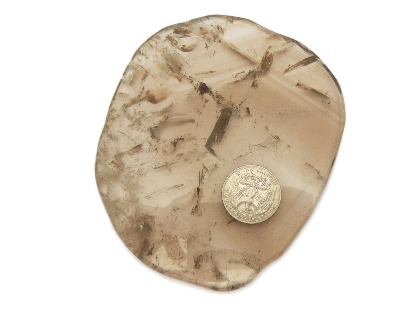 smokey quartz coaster with a quarter for size reference