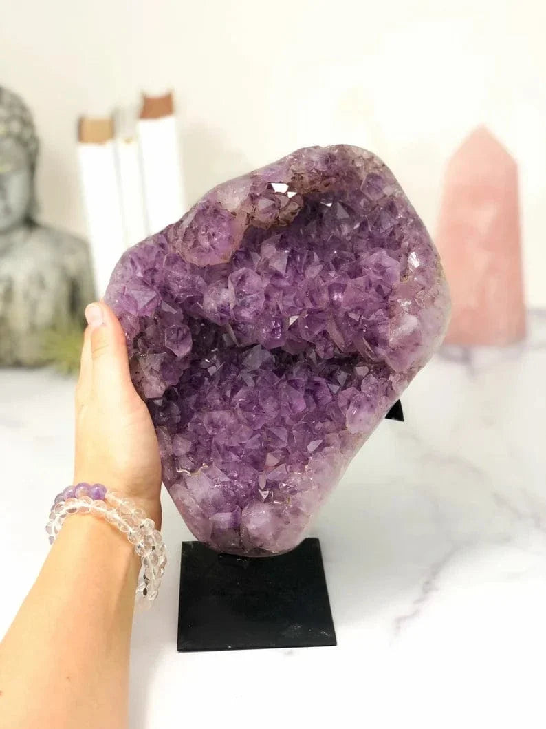 Amethyst Crystal Cluster on Metal Stand with a hand for size reference