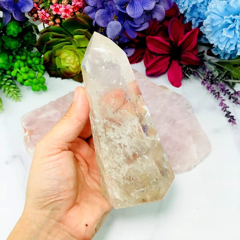 Crystal Quartz Polished Tower front view on hand for size comparison