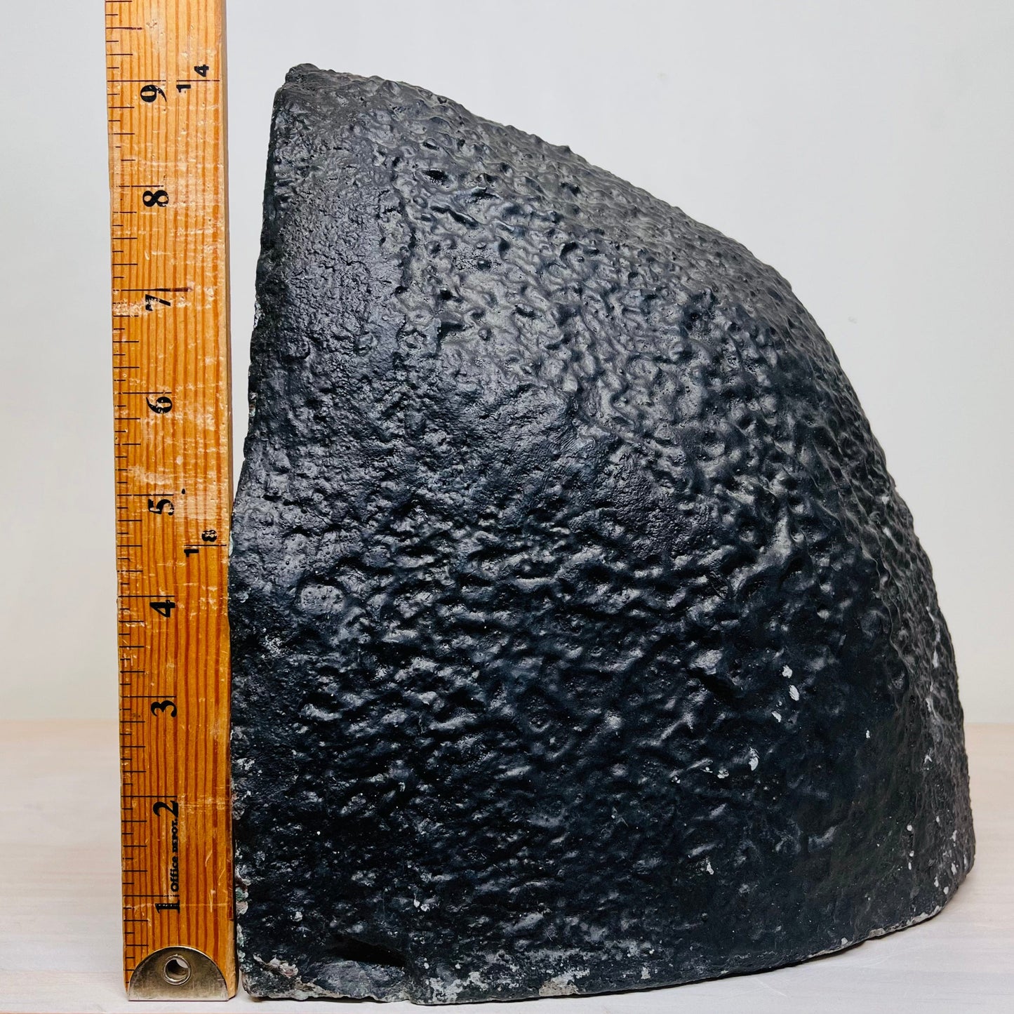 View of the Amethyst Cluster Geode Cave's right side, next to an upright ruler for size reference.