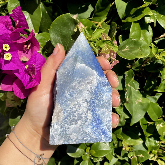 blue quartz polished point in hand 