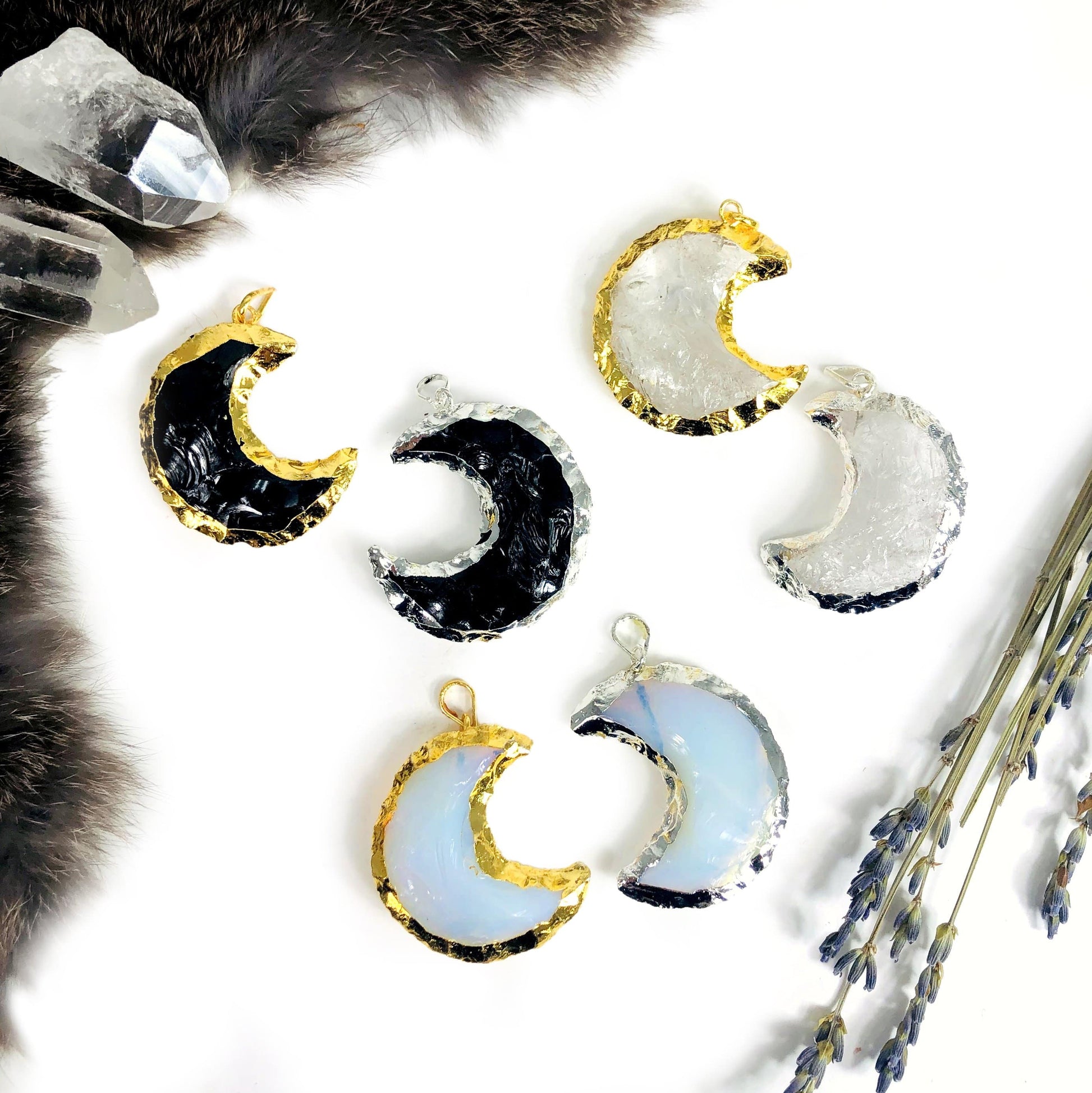 gemstone moon pendants displayed to show the differences in the crystals 