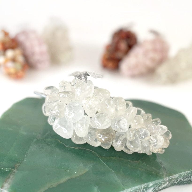 crystal quartz stone grapes up close and other one sin the distance behind