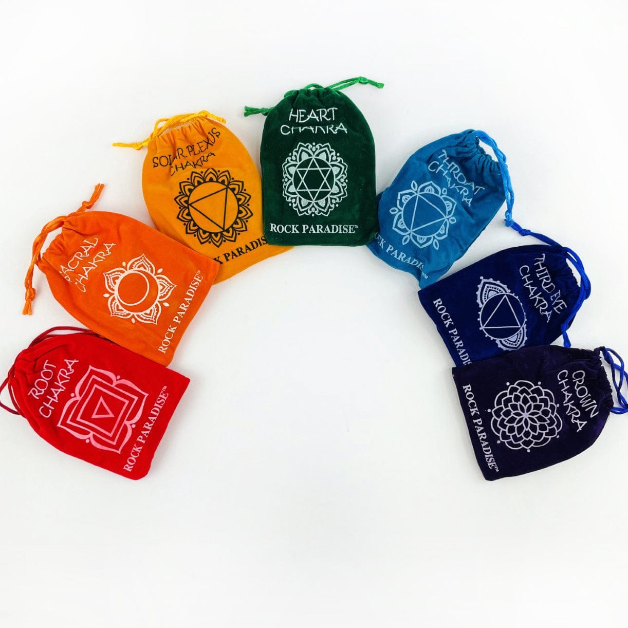 All the 7 different chakra stone sets lined up in an arch