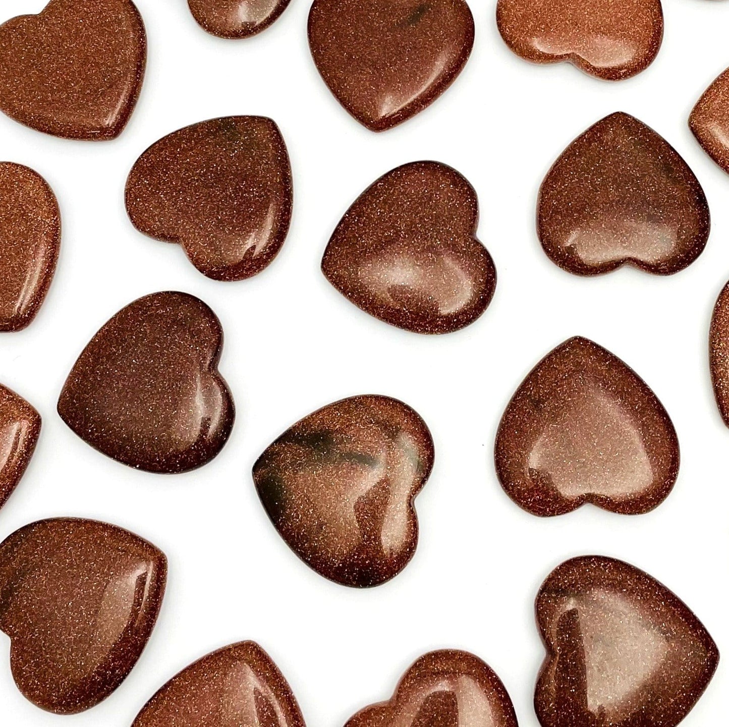 multiple heart shaped goldstones next to one another to show their different designs