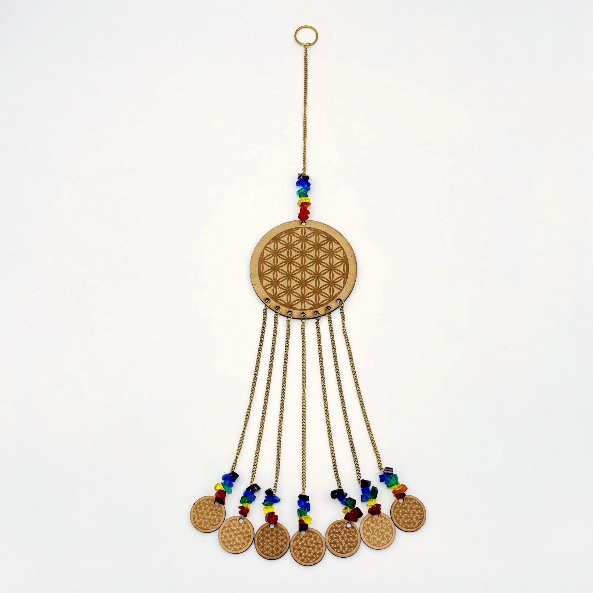 Beautiful Engraved Flower of Life on a wooden circle with attached mini engraved wood circles on white background.