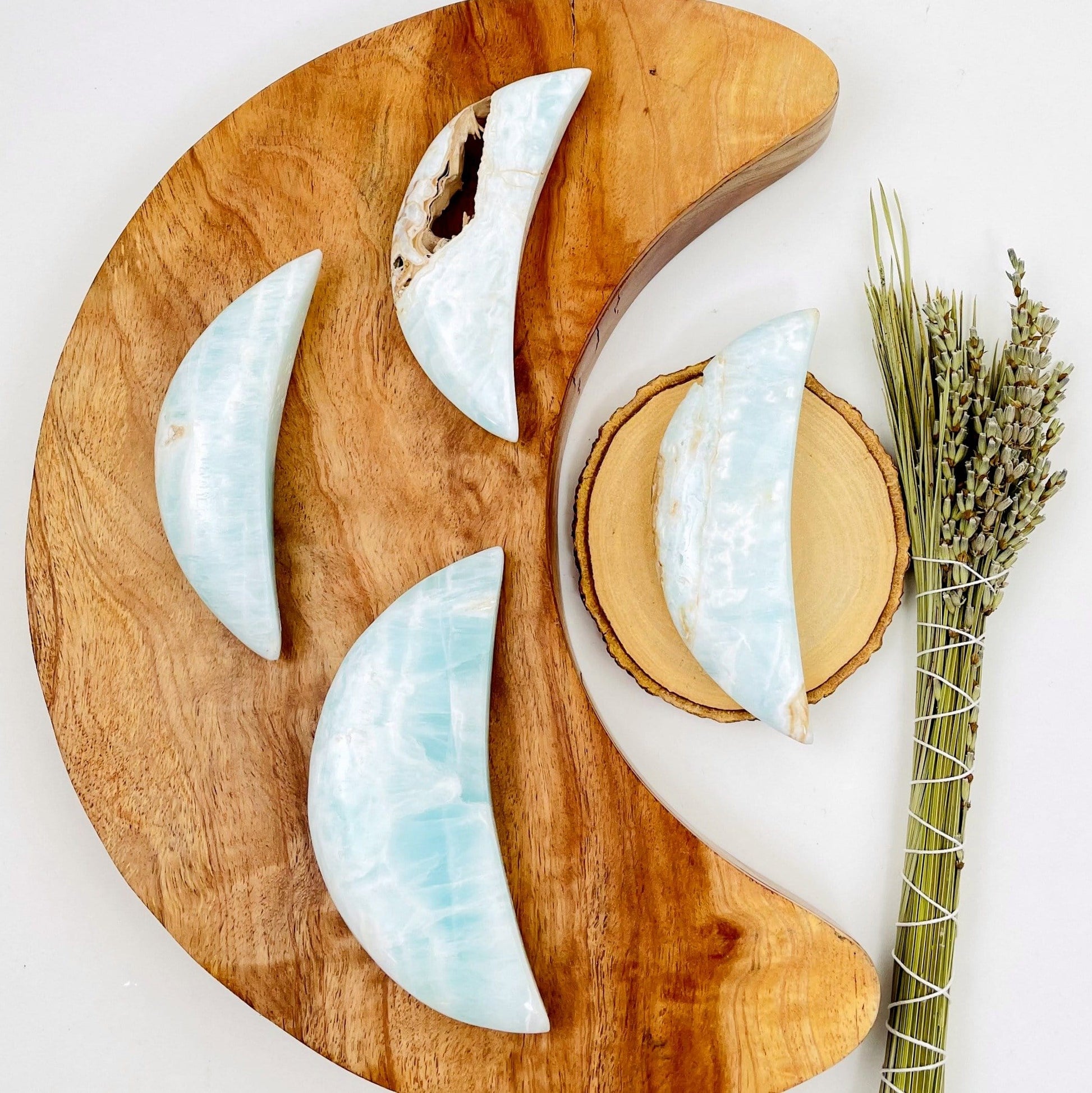 4 argonite blue with brown hints on some not all laid out on a wood and white background.