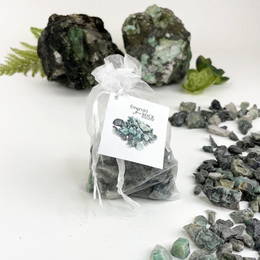 Rough emerald stones tied and tagged in an organza bag