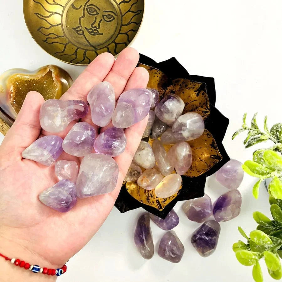 1 lb Amethyst Tumbled Gemstones with some in a hand for size reference