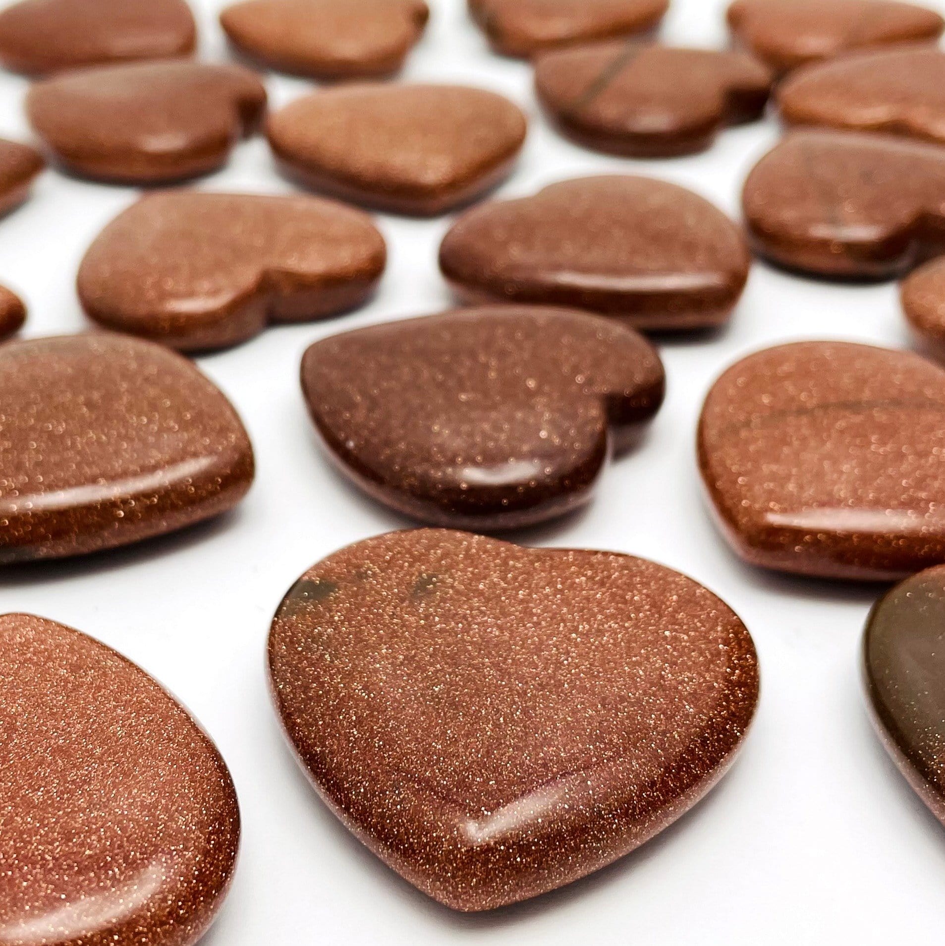 side shot of the heart shaped goldstones to show difference in thickness