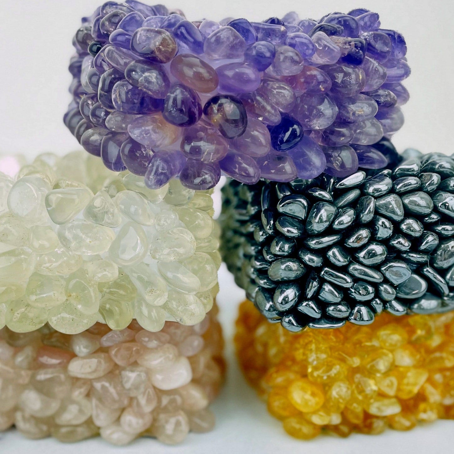 various types of tumbled stone heart candle holders stacked on each other