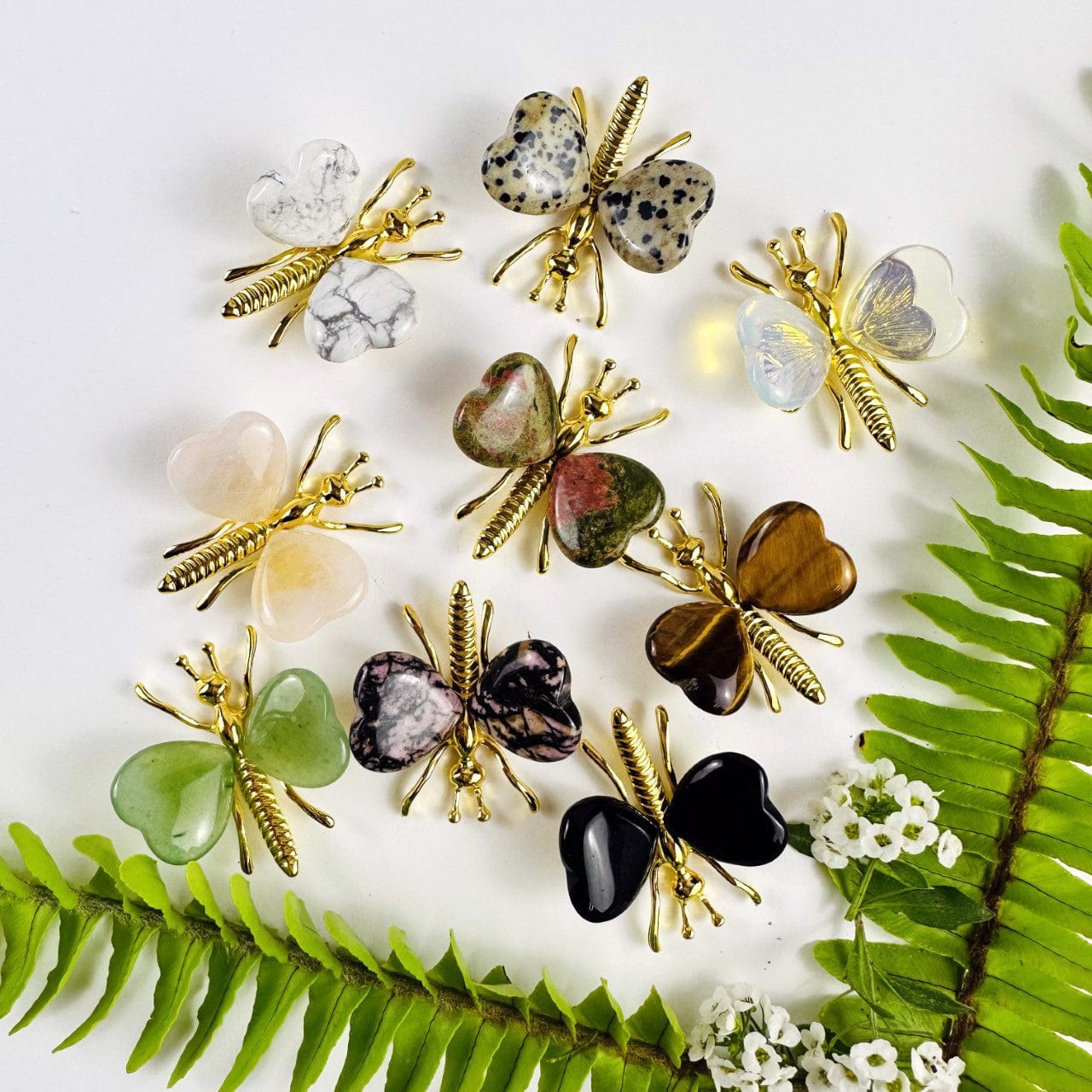 Gemstone Butterflies with Gold Tone Body on a table showing the assorted stones we carry