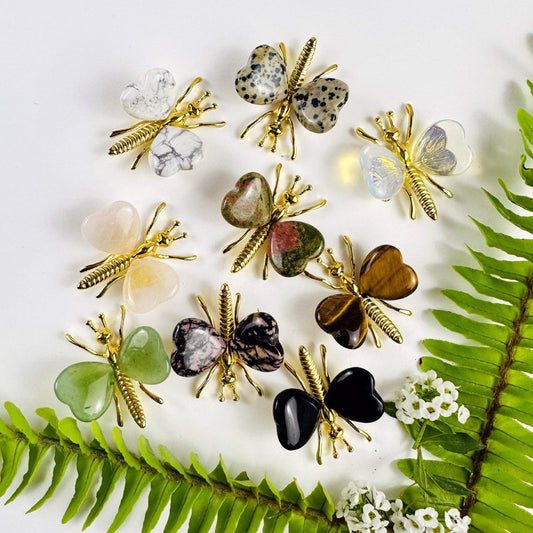 Gemstone Butterflies with Gold Tone Body on a table showing the assorted stones we carry