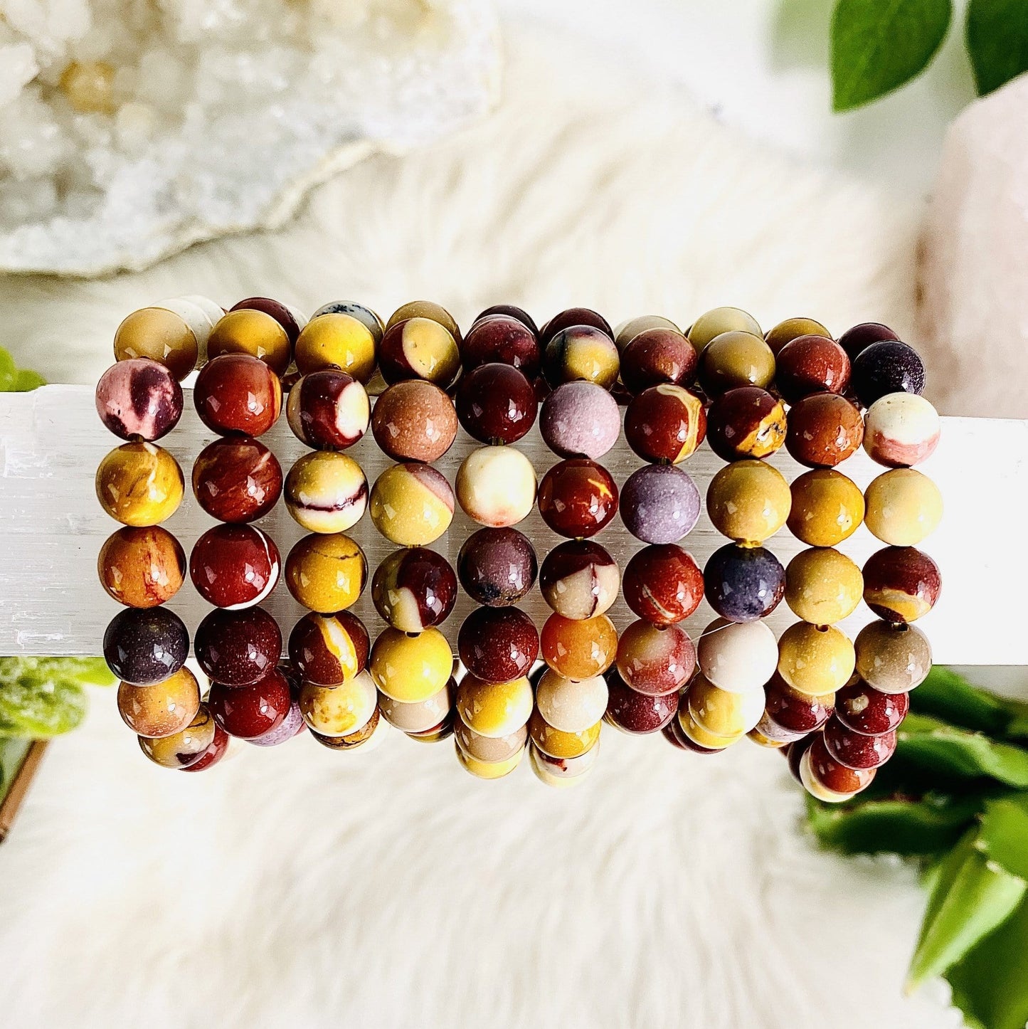 several bracelets to show mutlicolors of whites creams reds browns yellows golden yellow maroon shades