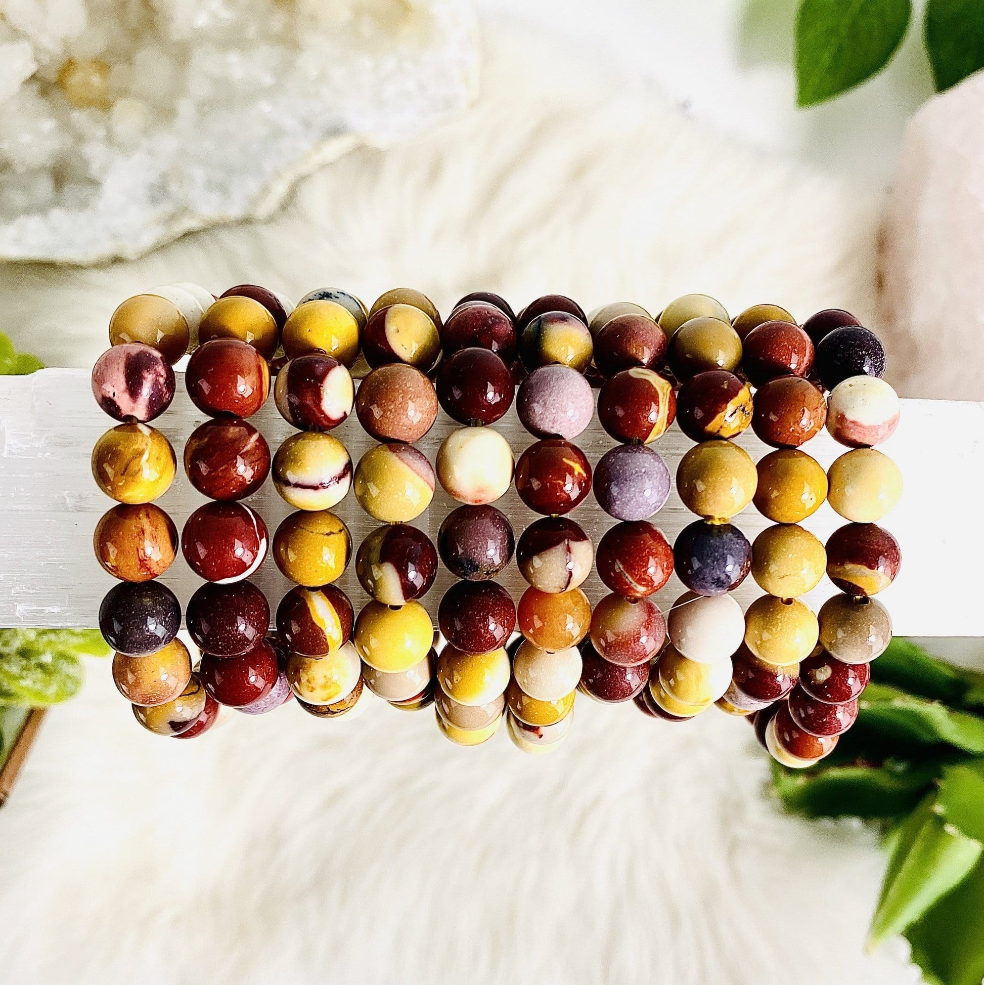several bracelets to show mutlicolors of whites creams reds browns yellows golden yellow maroon shades