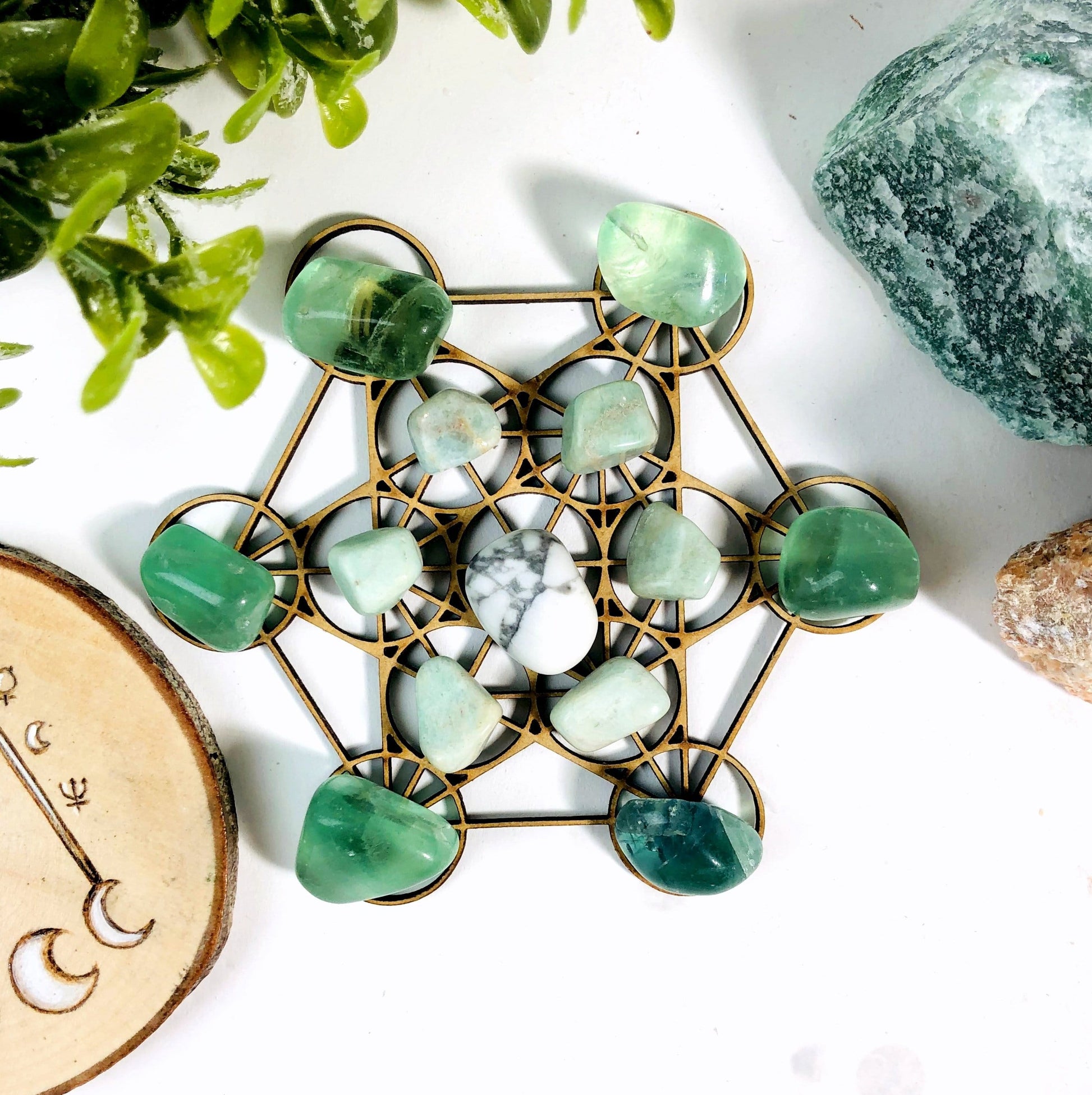 metatron crystal grid with crystals on top of it and decorations in the  background