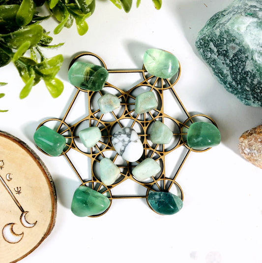 metatron crystal grid with crystals on top of it and decorations in the  background