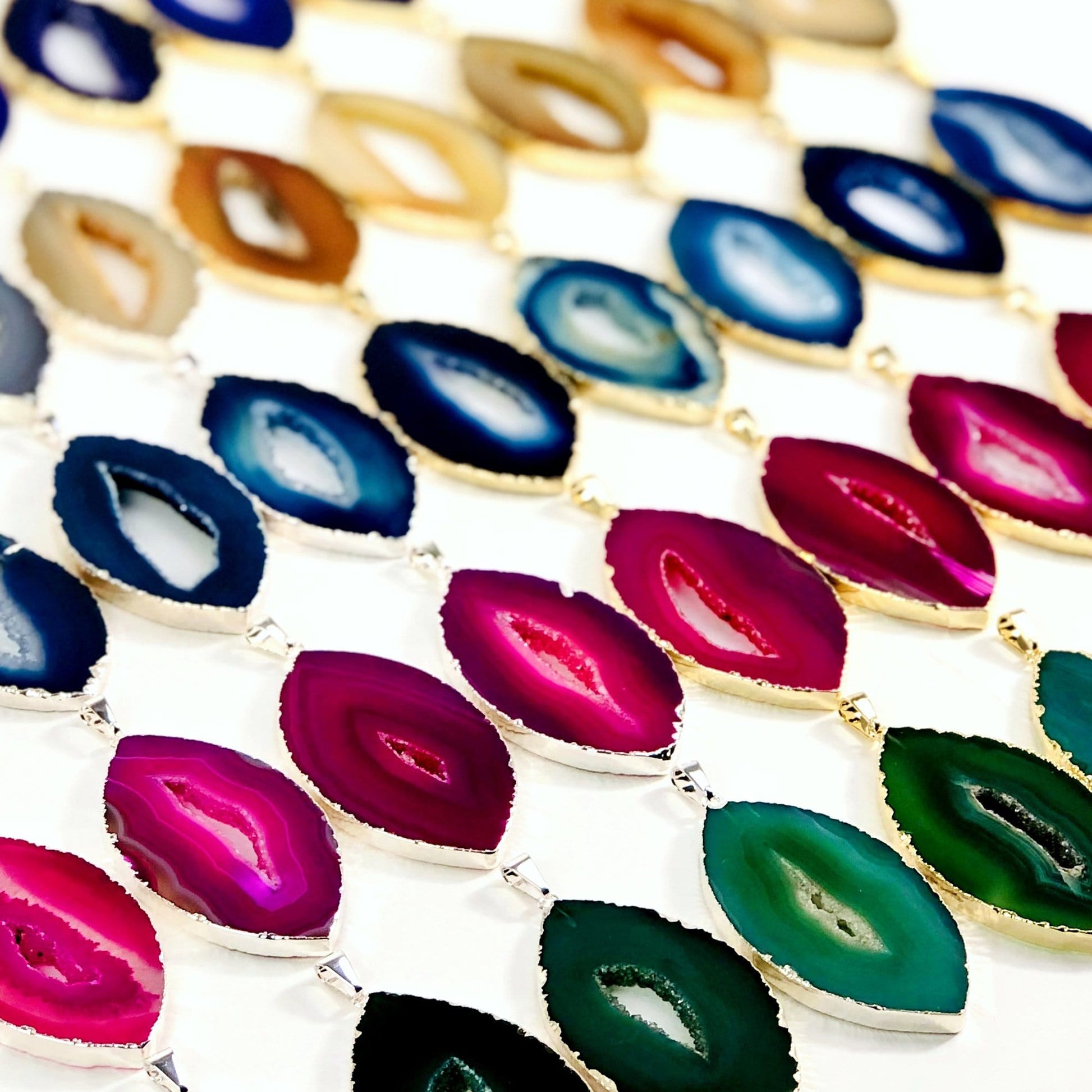 An angled view of Agate Druzy Pendants Extra Grade Agates Marquise Shape to show thickness.