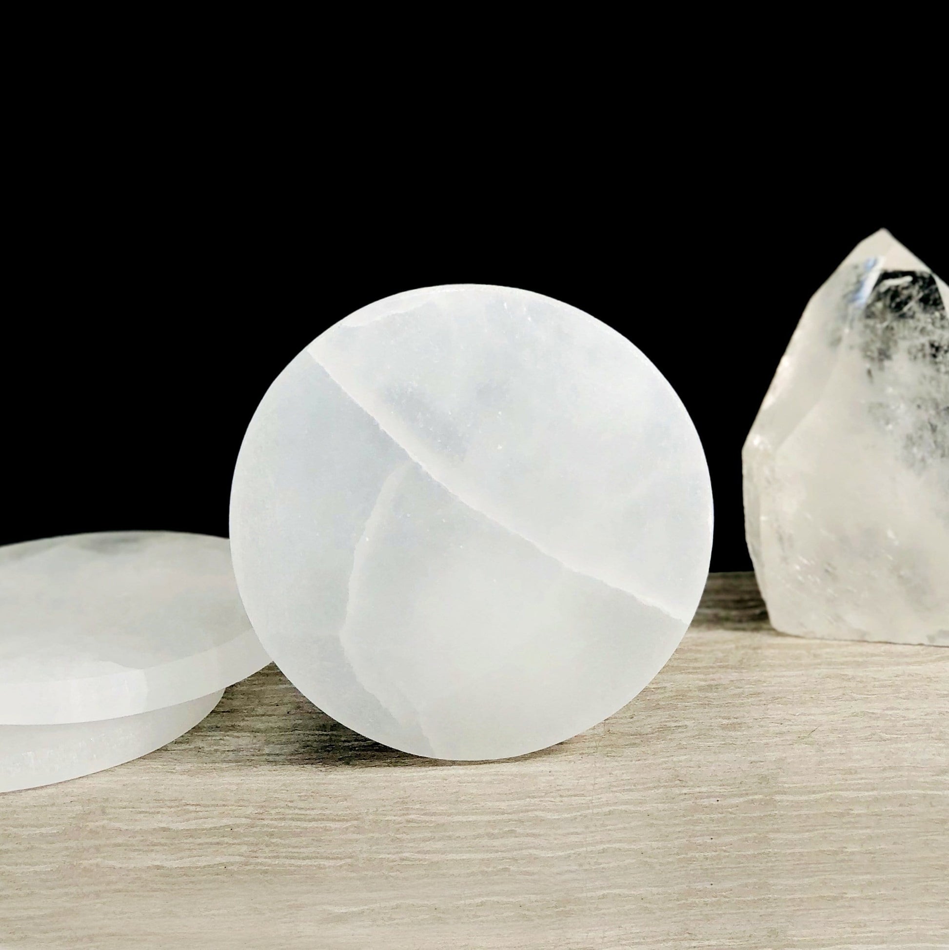 10cm round selenite charging plate propped up
