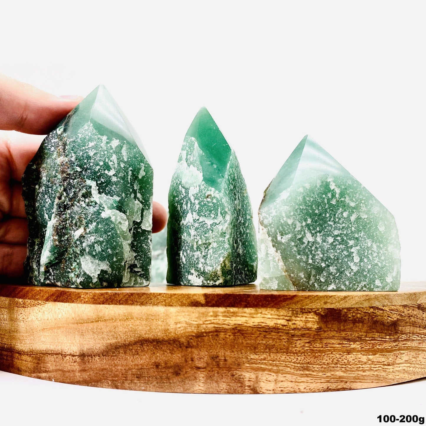hand next to green aventurine point