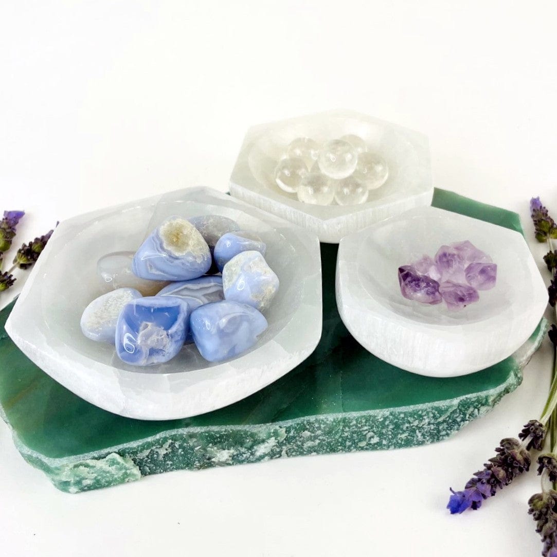 hexagon selenite bowl on display with stones for size reference