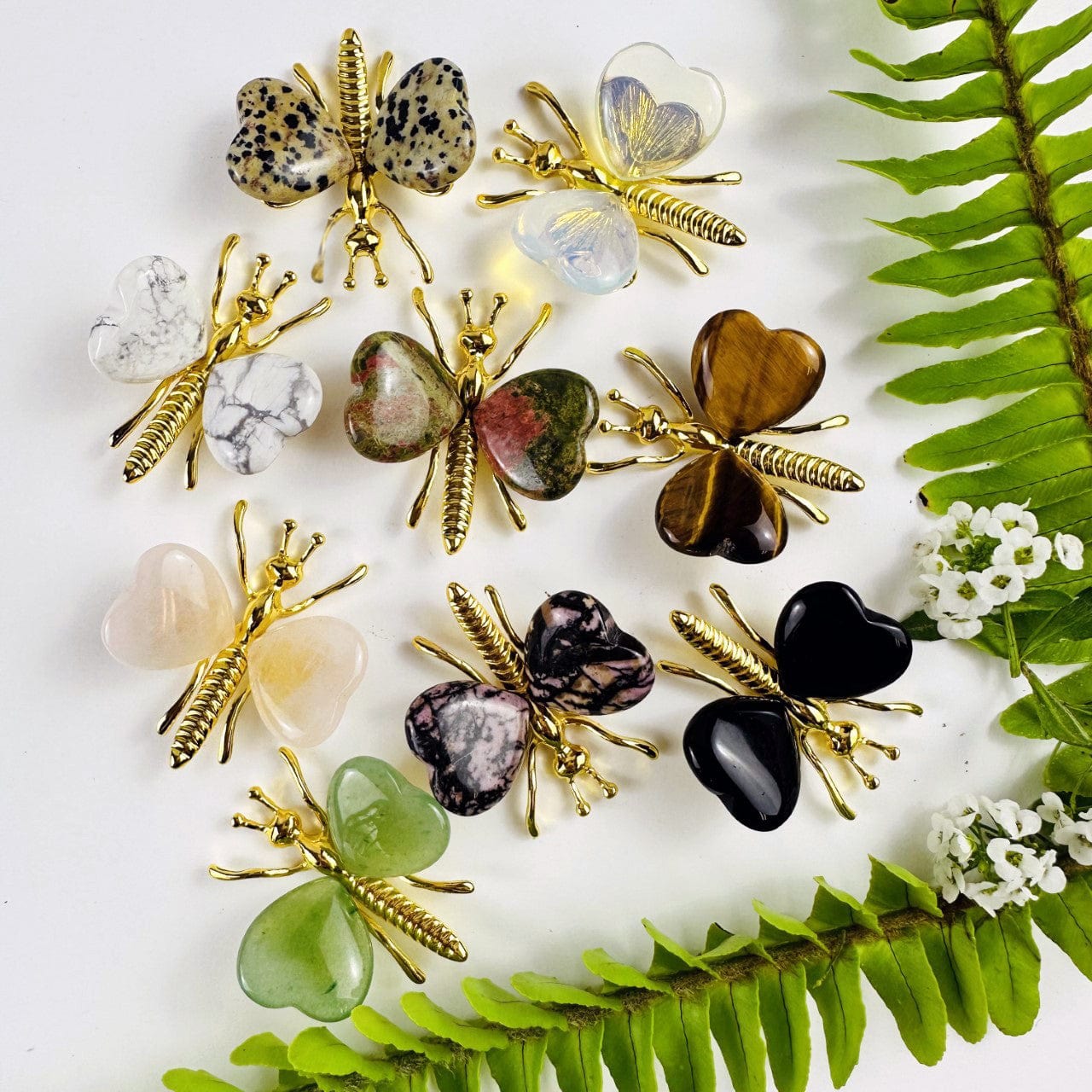 Gemstone Butterflies with Gold Tone Body on a table showing the assorted stones we carry