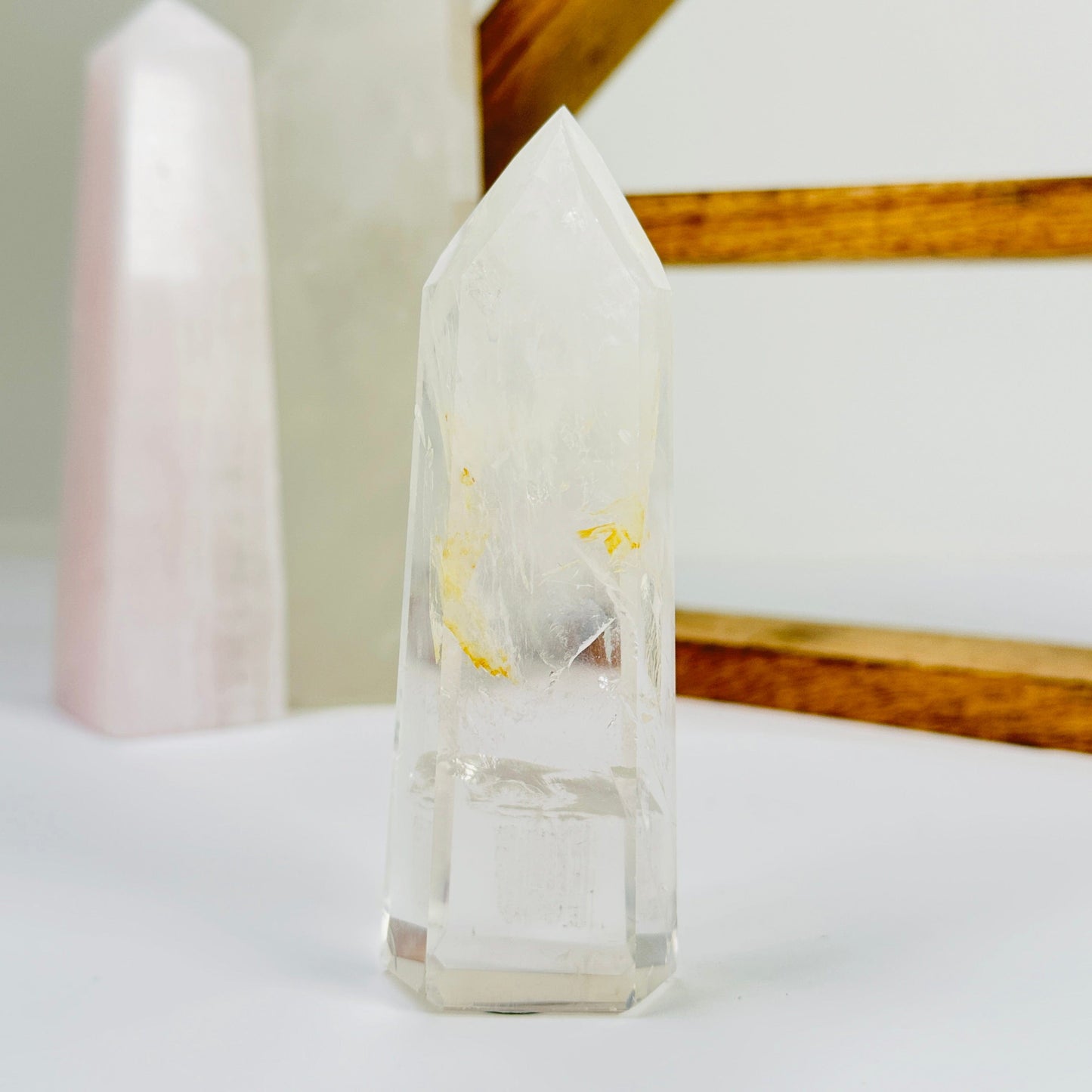 crystal quartz point with decorations in the background