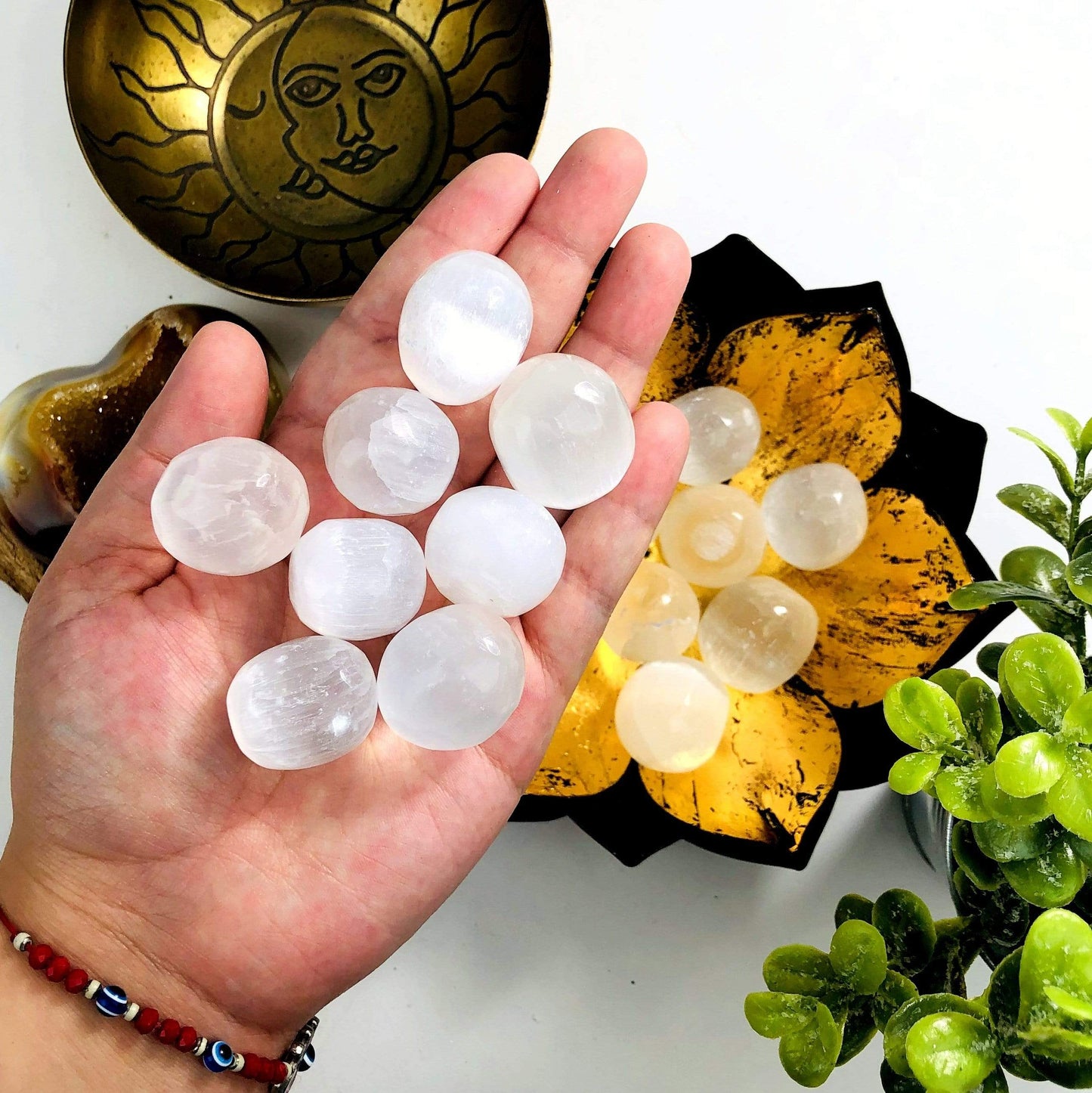 Selenite Tumbled Freeform stones in a hand for size reference