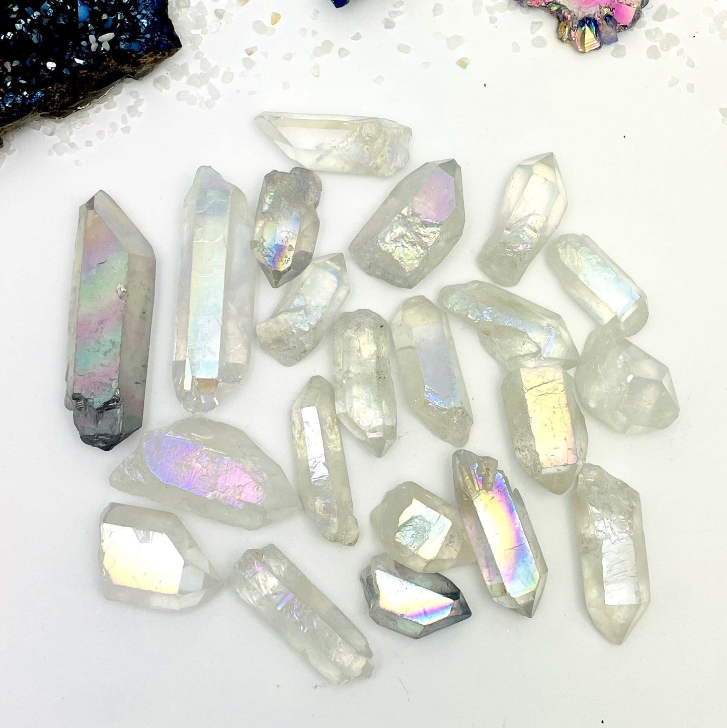 crystal quartz points coated in angel aura showing the different colors and size variations