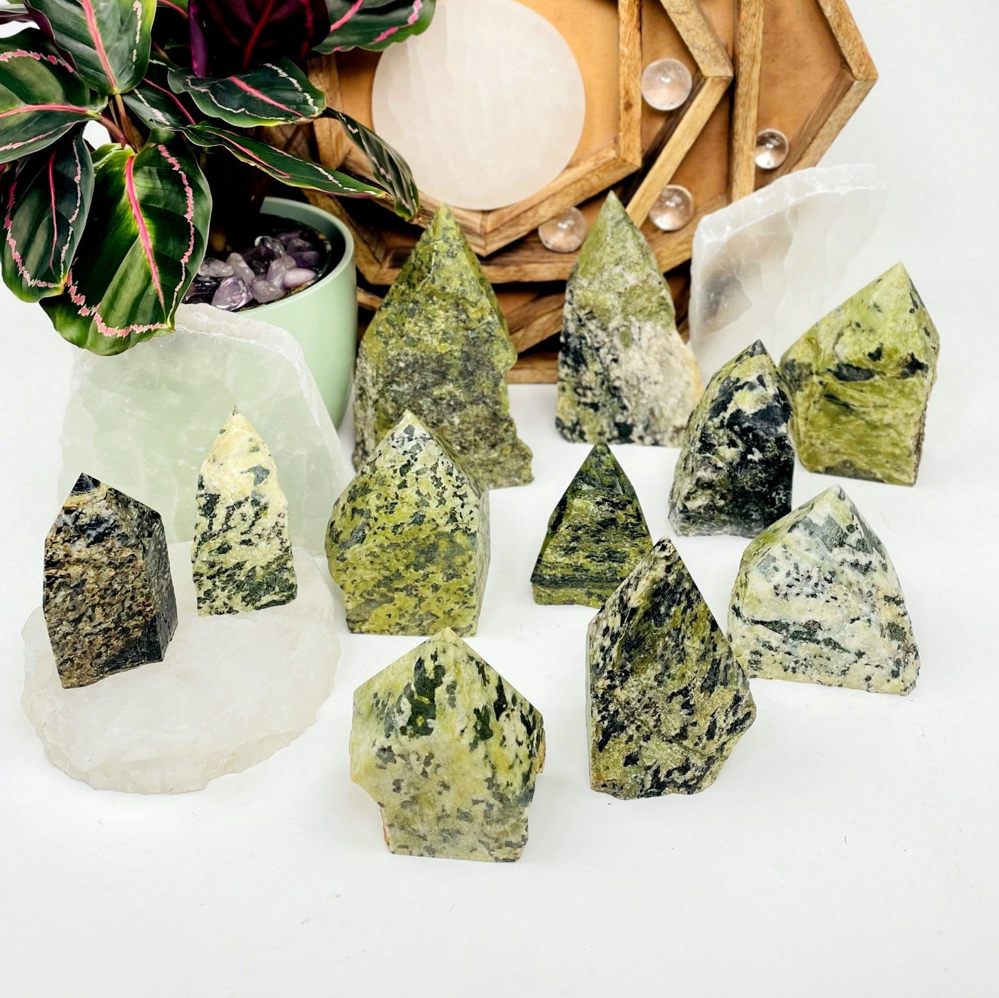 Eleven, various-sized Jadeite Semi-polished Points displayed on white surface.