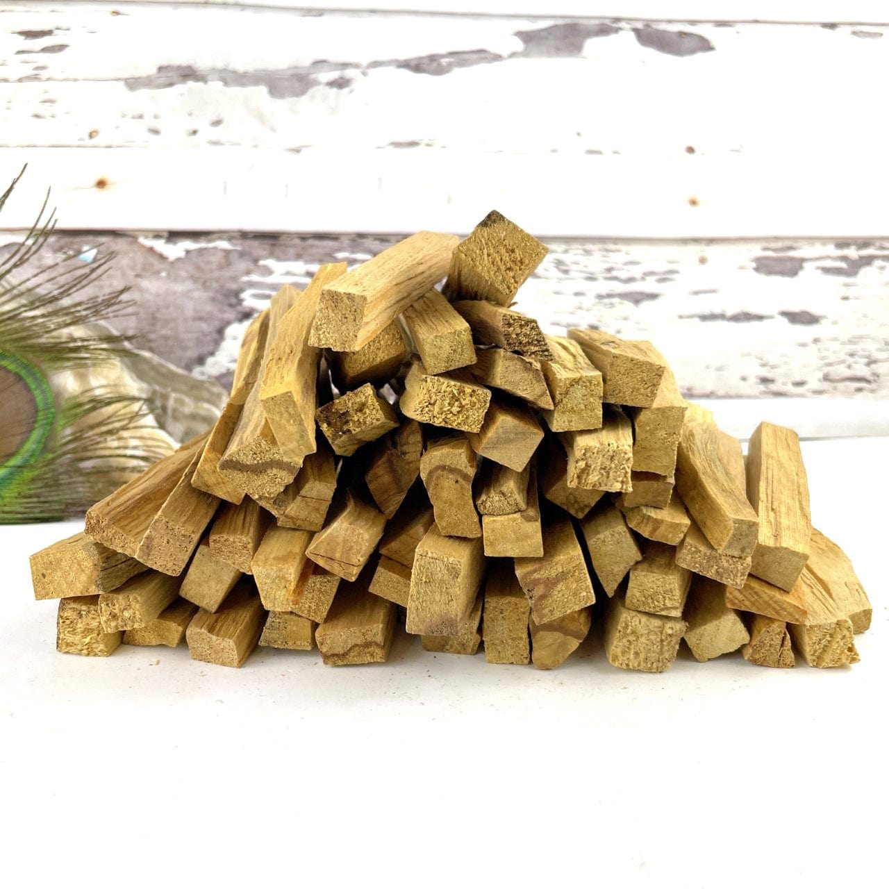 A pile of palo santo sticks on a white background.