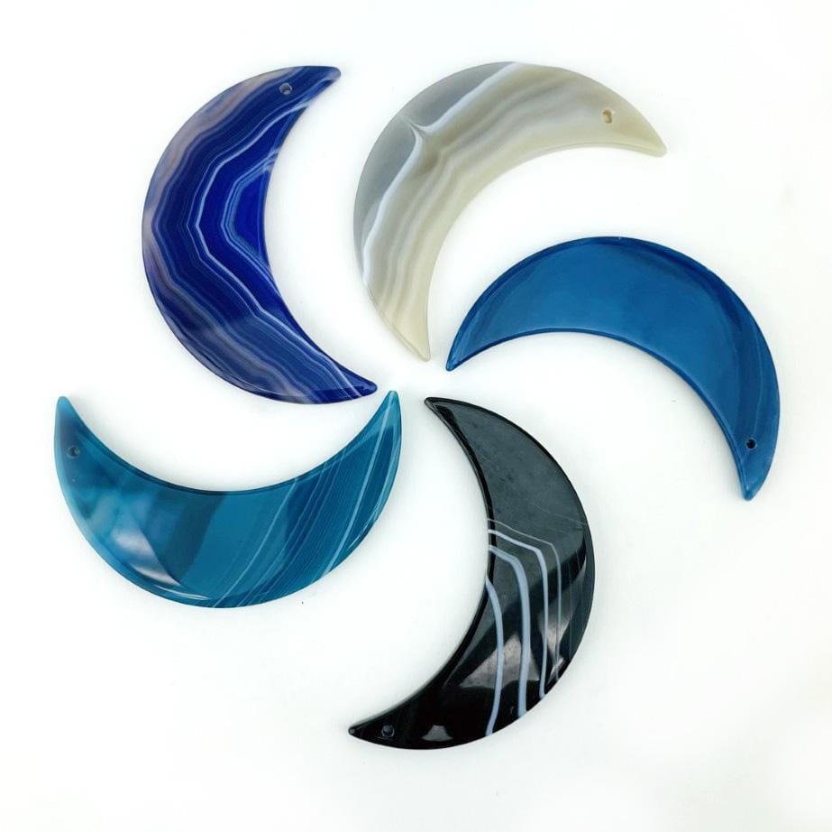 Close up of agate moons on a white surface.