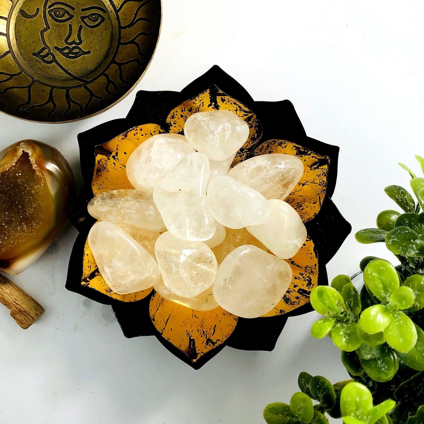 Crystal Quartz tumbled stones in a lotus metal bowl.