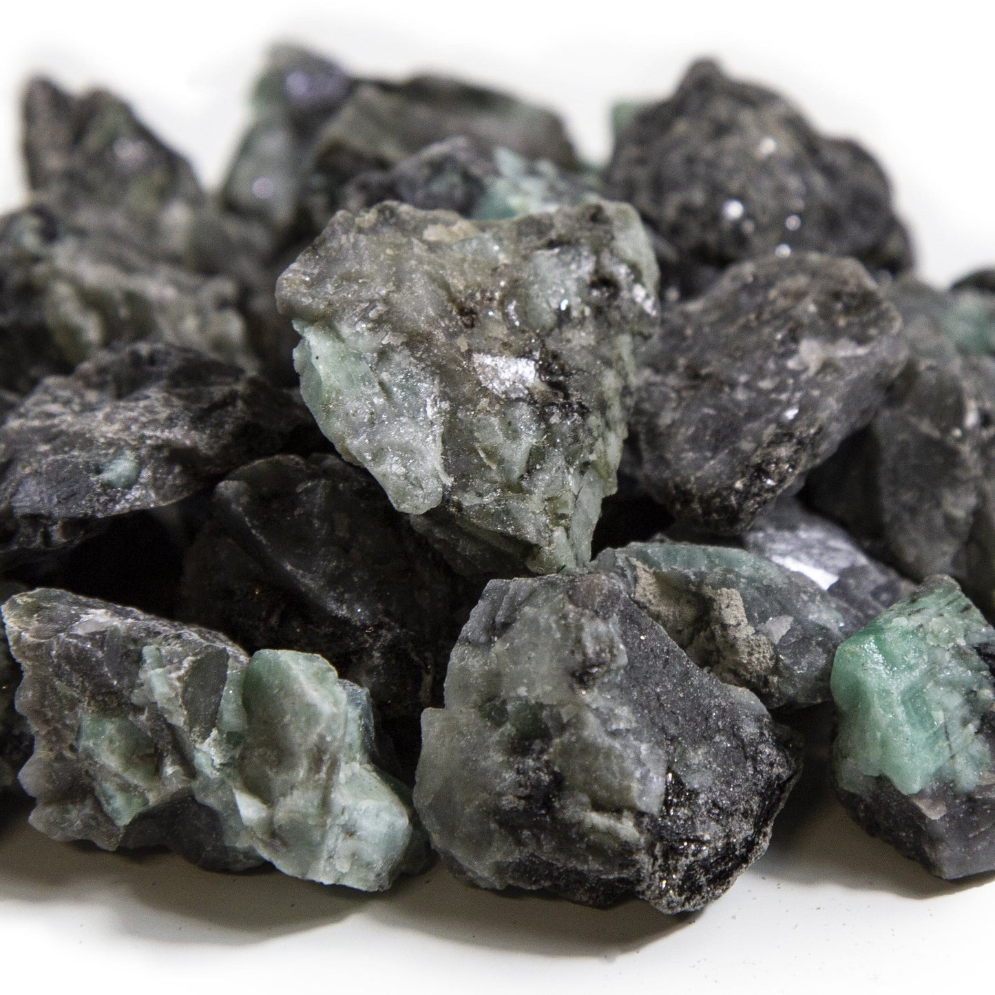 emerald rough stones with decorations in the background