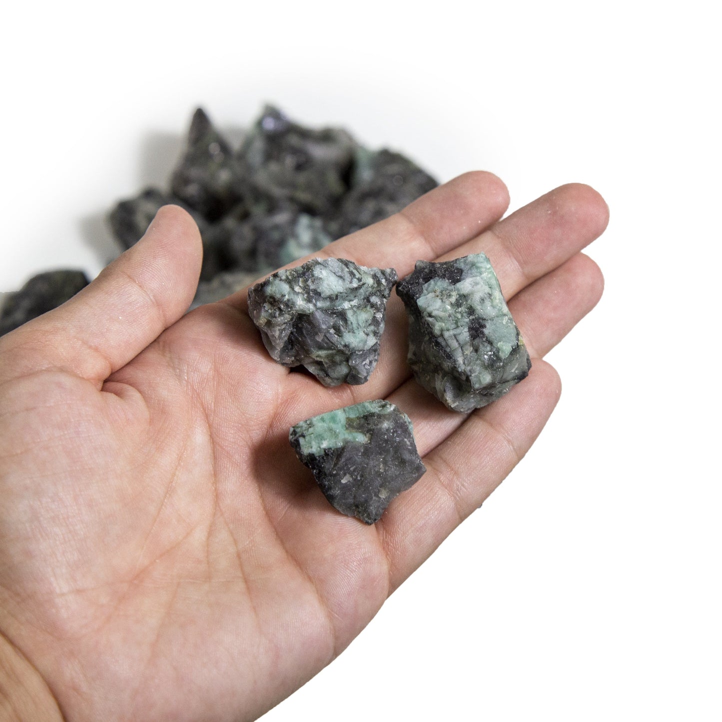 emerald rough stones with decorations in the background