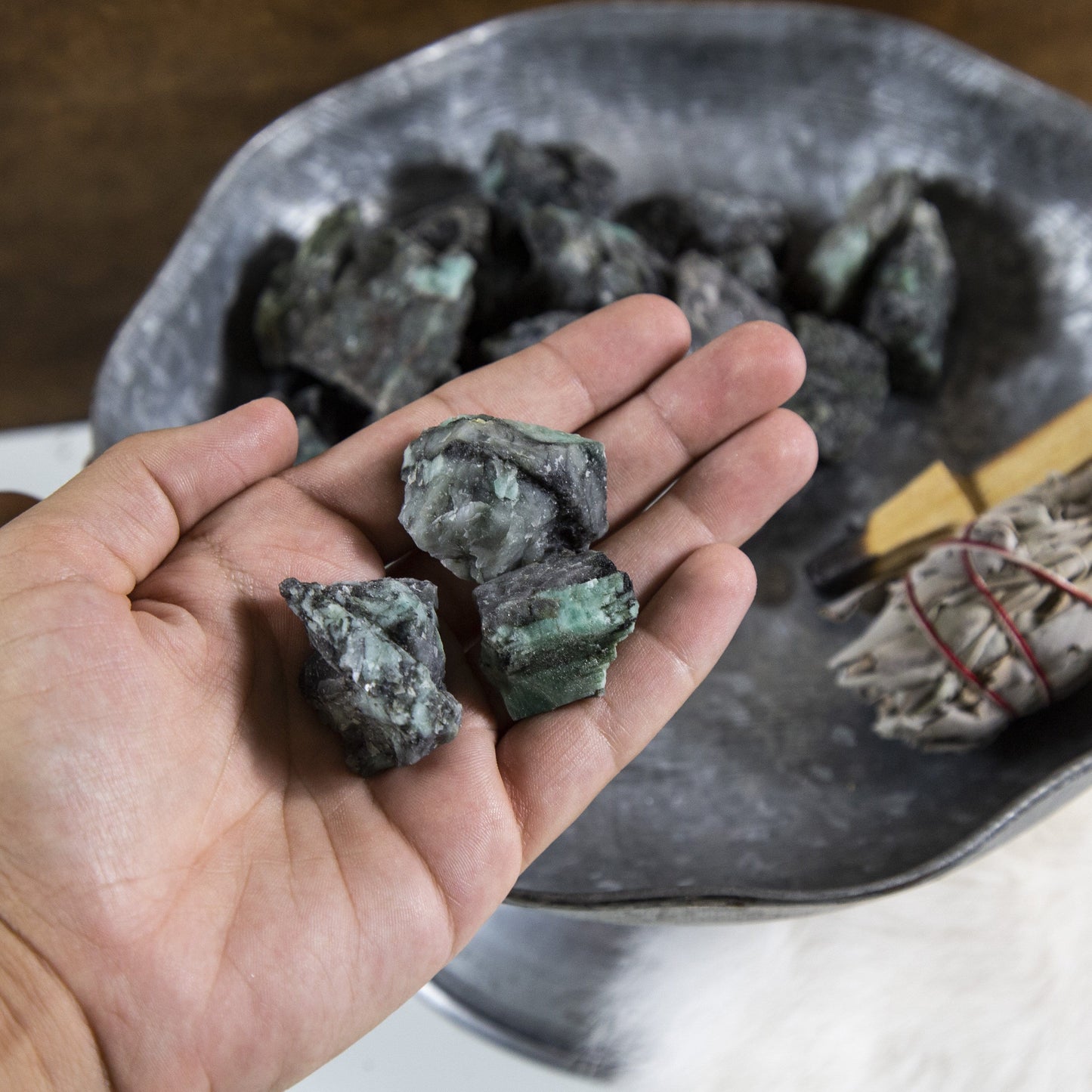 emerald rough stones with decorations in the background