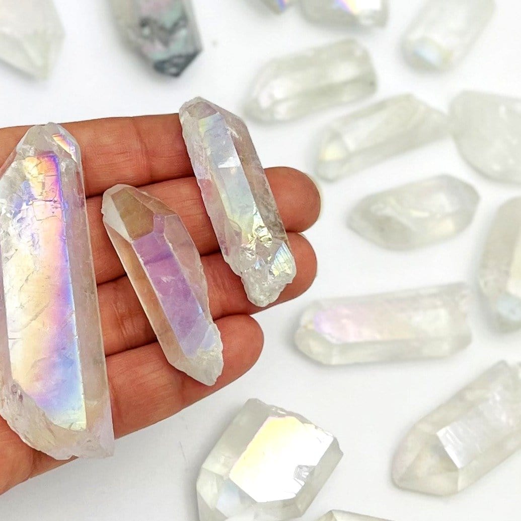 crystal quartz points coated in angel aura showing the different colors and size variations