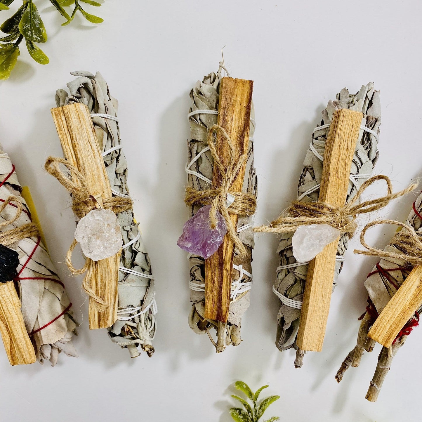 sage palo santo bundles with stone pendant options on display