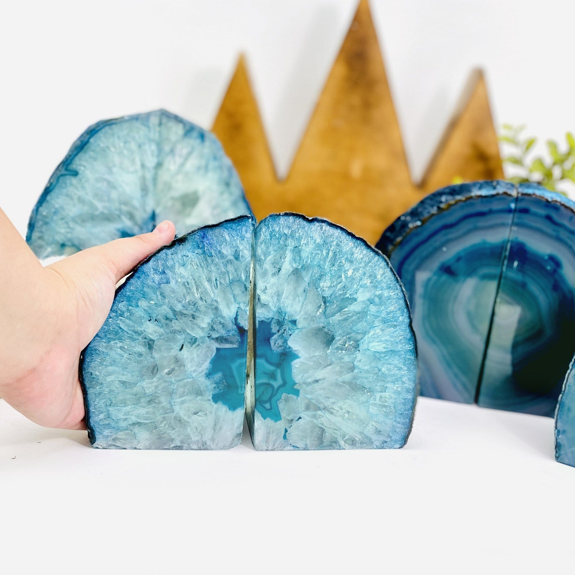  Teal Agate Bookend Pair shown front facing and a hand.