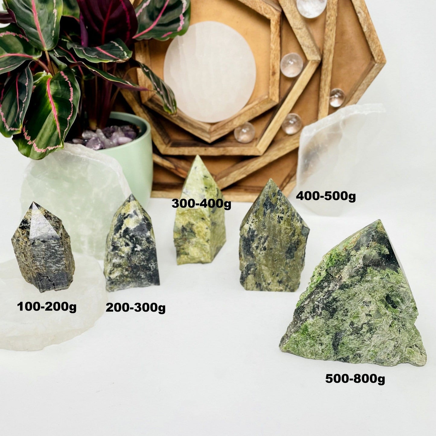 5 different sized Jadeite Semi-polished Points displayed on a white surface with weights listed next to them.