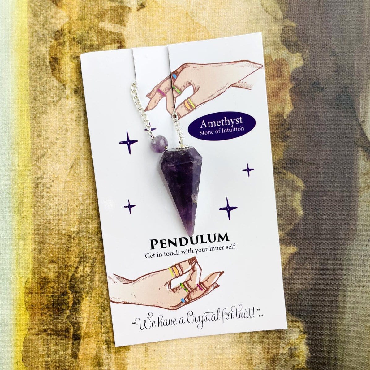 amethyst crystal pendulum on information card
