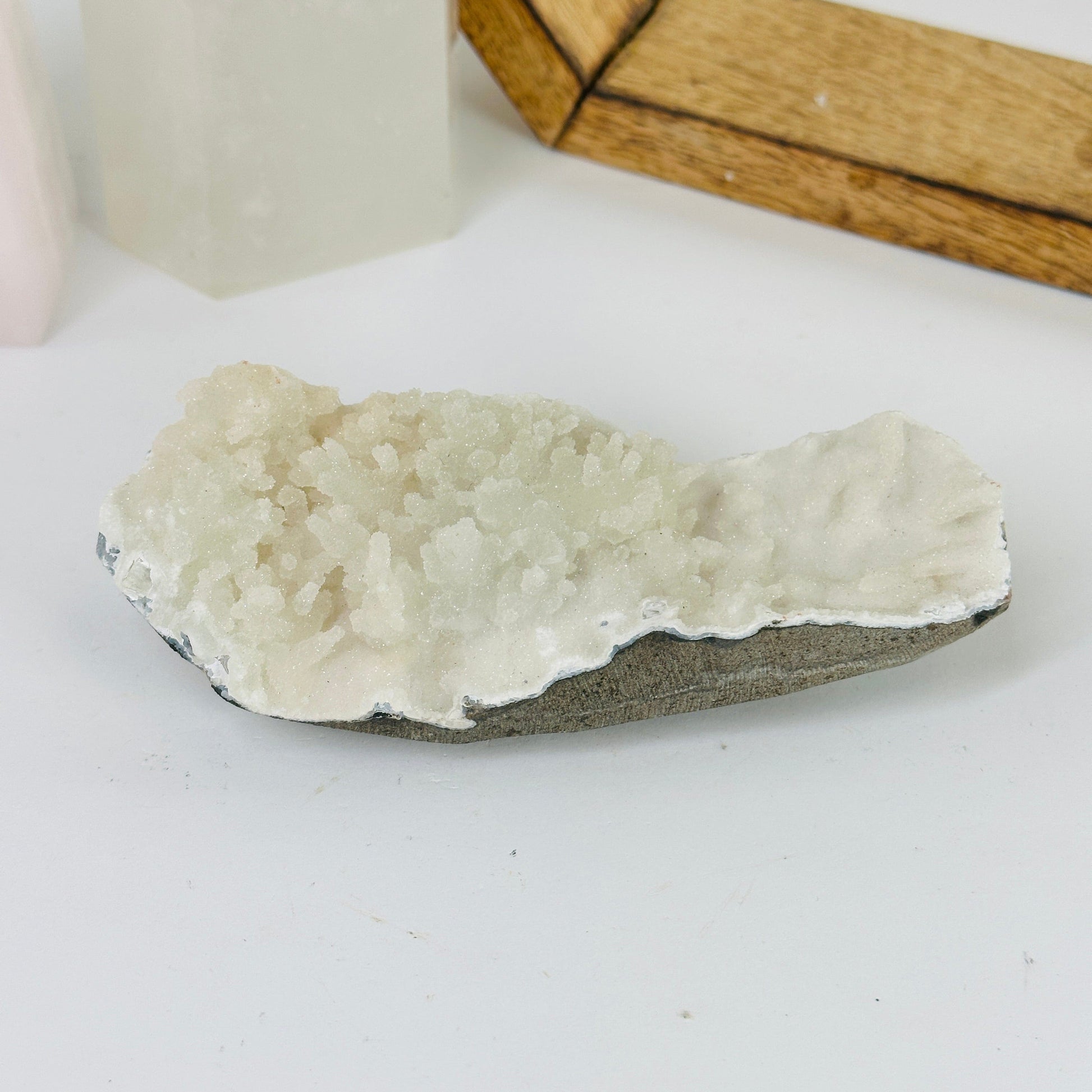 apophyllite on matrix with decorations in the background